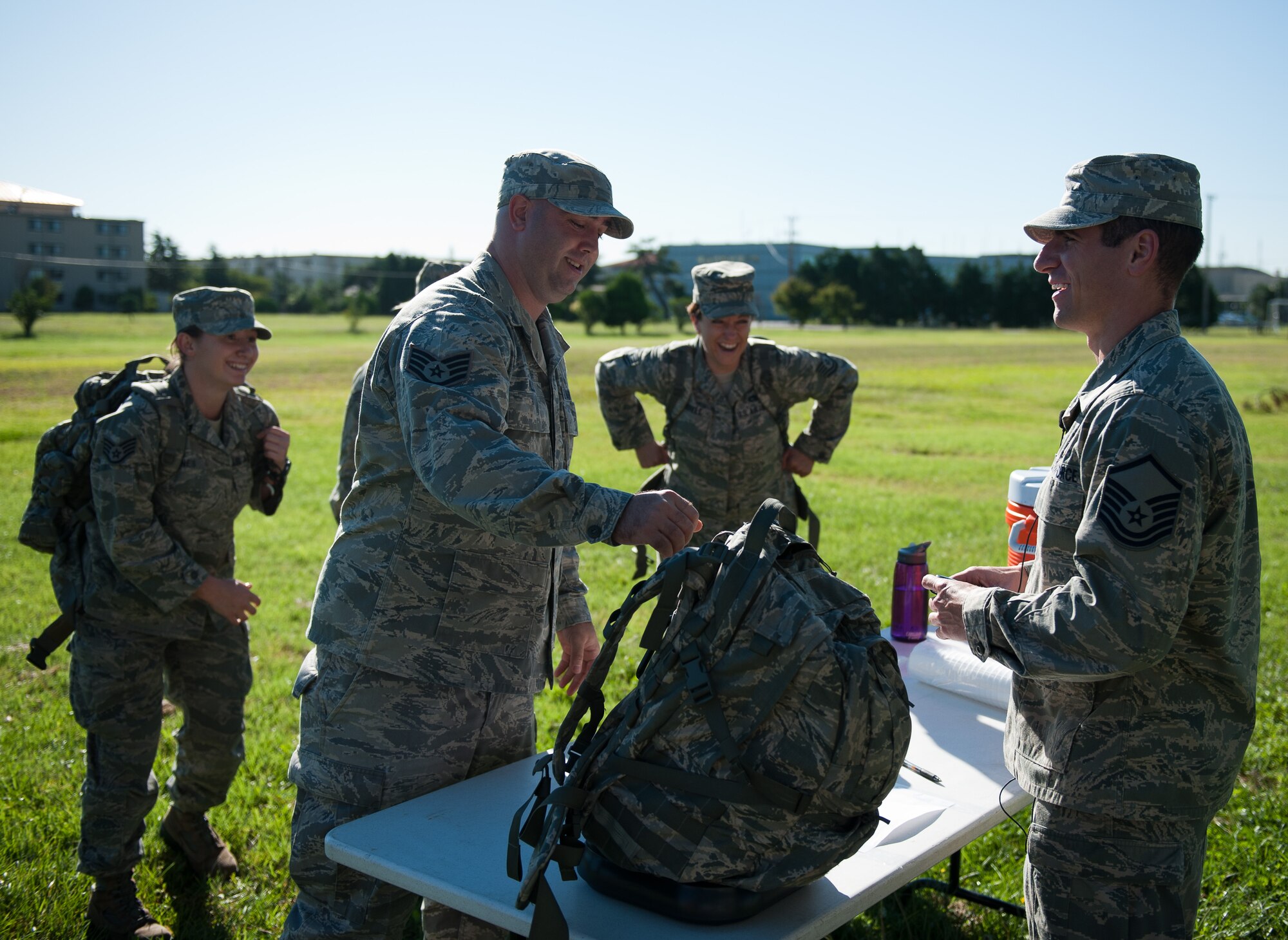Master Sgt. Ryan Bobzin, 8th Civil Engineer Squadron, weighs a rucksack for Staff Sgt. Dillon Mills, 8th Maintenance Squadron, before the Kunsan Prisoner of War and Missing In Action Ruck March at Kunsan Air Base, Republic of Korea, Sept. 16, 2013. The Wolf Pack started a week of honoring prisoners of war and those missing in action with a five-mile march while carrying at least 40 pounds. (U.S. Air Force photo by Senior Airman Clayton Lenhardt/Released)