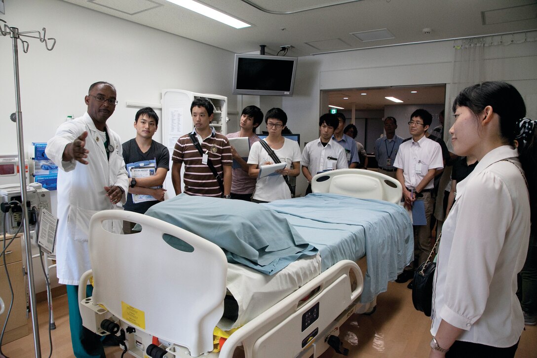 Lt. Cmdr. Gene Sherrod, far left, gives visiting students and physicians from the University of the Ryukyus a tour of the intensive care unit Sept. 12 at U.S. Naval Hospital Okinawa on Camp Foster. Sherrod is the ICU department head at USNH Okinawa.