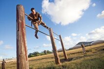 Cpl. Benjamin List, a Richmond, Mo. native and student in the Marine Corps Martial Arts Instructor Course, climbs over a double parallel bar during the obstacle course at Marine Corps Base Hawaii.