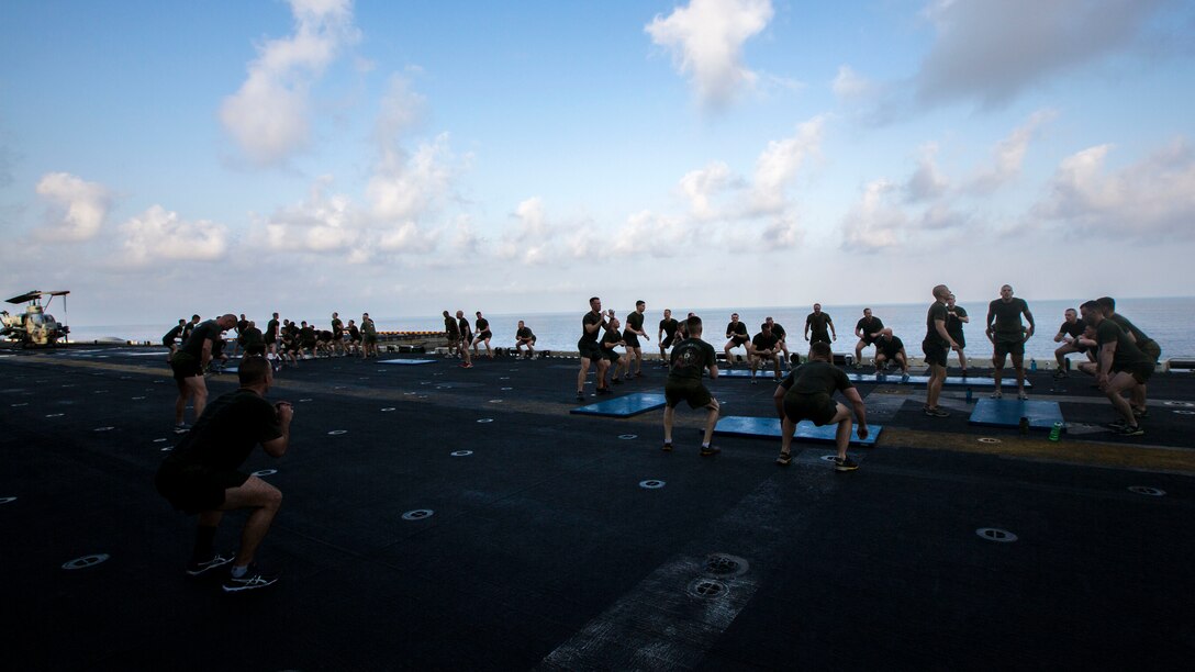 U.S. Marines assigned to Battalion Landing Team (BLT) 3/2, 26th Marine Expeditionary Unit (MEU), conduct physical training on the flight deck of the USS Kearsarge (LHD 3), Sept. 20, 2013.The 26th MEU is a Marine Air-Ground Task Force forward-deployed to the U.S. 5th and 6th Fleet areas of responsibility aboard the Kearsarge Amphibious Ready Group serving as a sea-based, expeditionary crisis response force capable of conducting amphibious operations across the full range of military operations. (U.S. Marine Corps photo by Sgt. Christopher Q. Stone, 26th MEU Combat Camera/Released)