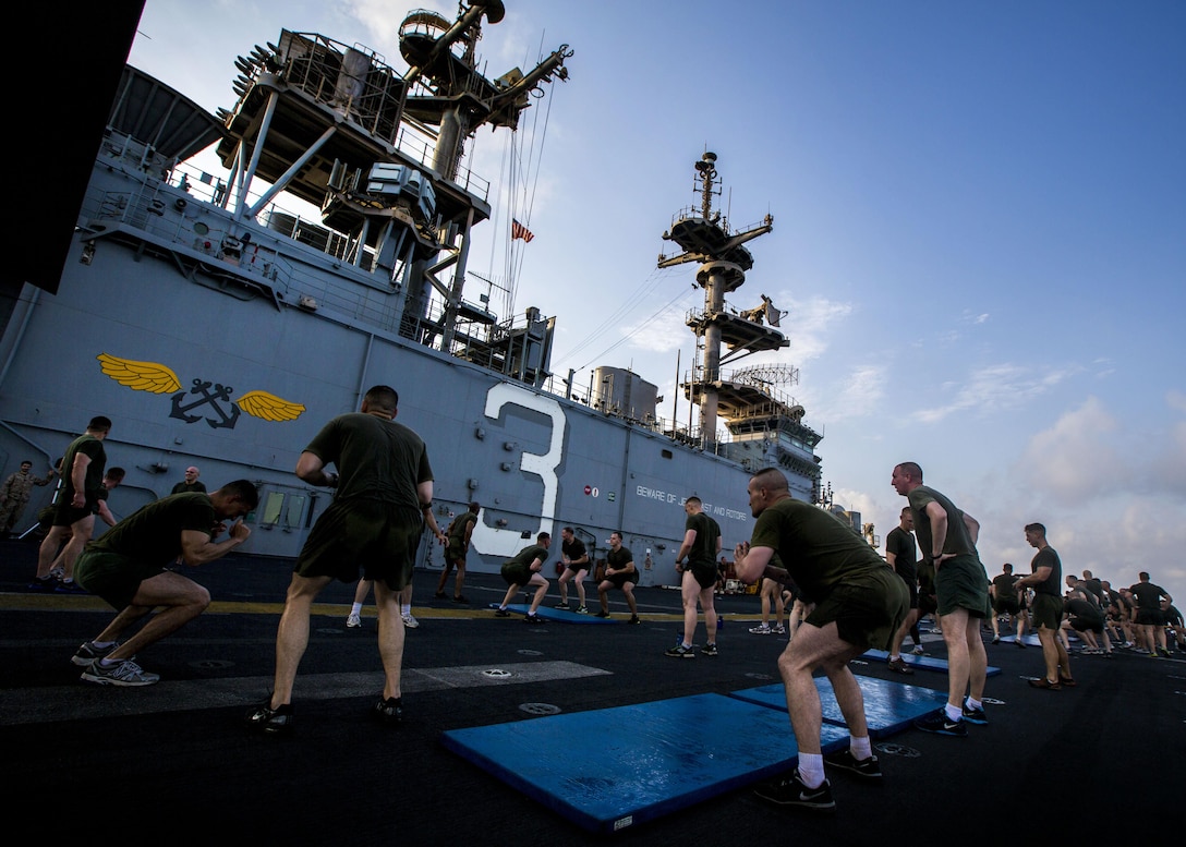 U.S. Marines assigned to Battalion Landing Team (BLT) 3/2, 26th Marine Expeditionary Unit (MEU), conduct physical training on the flight deck of the USS Kearsarge (LHD 3), Sept. 20, 2013.The 26th MEU is a Marine Air-Ground Task Force forward-deployed to the U.S. 5th and 6th Fleet areas of responsibility aboard the Kearsarge Amphibious Ready Group serving as a sea-based, expeditionary crisis response force capable of conducting amphibious operations across the full range of military operations. (U.S. Marine Corps photo by Sgt. Christopher Q. Stone, 26th MEU Combat Camera/Released)