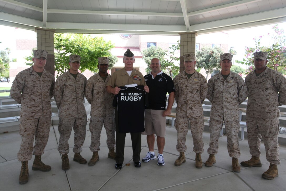 Lt. Gen. John A. Toolan, the commanding general of I Marine Expeditionary Force, meets with members of the Marine Corps Rugby team and their coach at Camp Pendleton, Calif., Sept. 13. Toolan presented the teammates with coins to recognize the player's hard work.