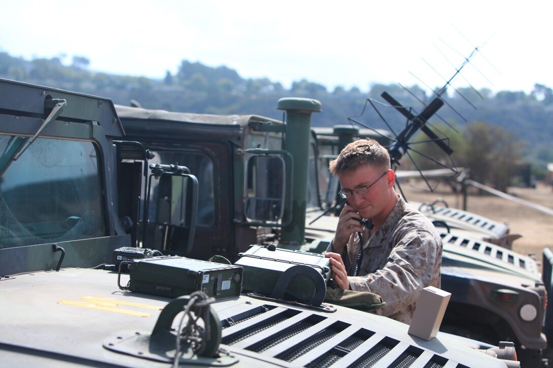 Lance Cpl. Derek Heeter, field radio operator, 9th Communication Battalion, checks radio connection during a month long field exercise. 9th Com Bn., simulated a 1st Marine Expeditionary Brigade deployment situation.