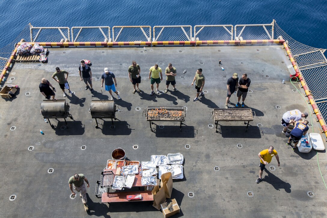 U.S. Marines and sailors assigned to 26th Marine Expeditionary Unit (MEU), grill food on an aircraft elevator of the USS Kearsarge (LHD 3) during a steel beach Morale Welfare and Recreation event, Sept. 20, 2013.The 26th MEU is a Marine Air-Ground Task Force forward-deployed to the U.S. 5th and 6th Fleet areas of responsibility aboard the Kearsarge Amphibious Ready Group serving as a sea-based, expeditionary crisis response force capable of conducting amphibious operations across the full range of military operations. (U.S. Marine Corps photo by Sgt. Christopher Q. Stone, 26th MEU Combat Camera/Released)