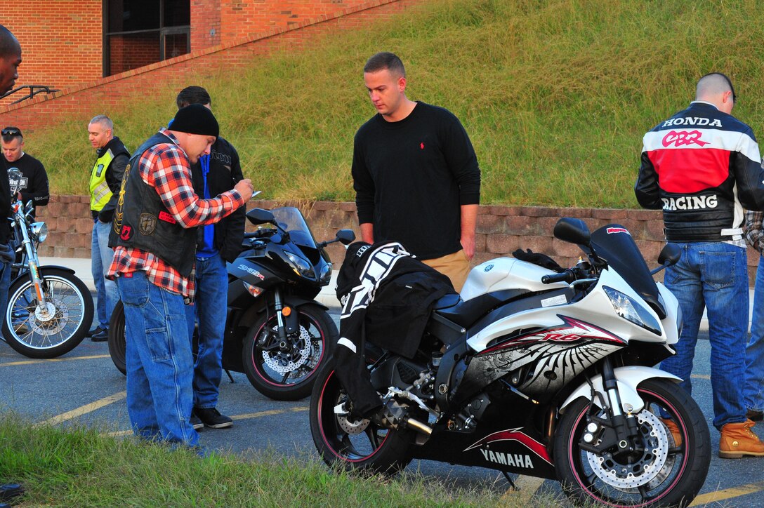 Gunnery Sgt. William Foster performs a safety check on Cpl. Andrew Crane’s motorcycle before a motorcycle ride to Manassas, on Sept. 19, 2013. Headquarters and Service Bn. sponsored the ride to Manassas National Battlefield Park. 