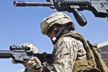 Cpl. Taylor Mejia, an intelligence analyst deployed to Afghanistan with the 3rd Marine Aircraft Wing (Forward), practices weapon presentation drills. Warfighters will benefit from the Distributed Common Ground/Surface System, which provides the Marine intelligence analyst capabilities for enterprise search, content discovery, collaboration and workflow management. 