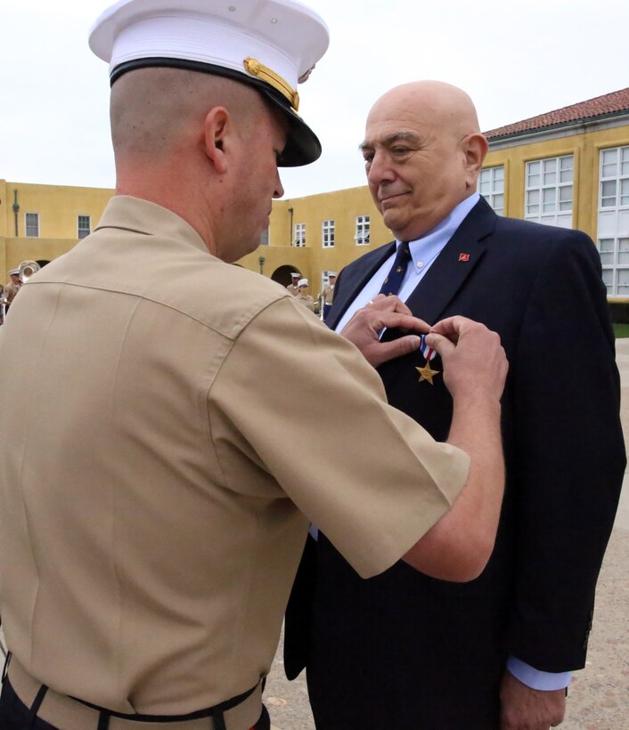 Brig. Gen. James W. Bierman, commanding general of Marine Corps Recruit Depot San Diego and Western Recruiting Region, awards Joe B. Cordileone the Silver Star medal during a morning colors ceremony aboard Marine Corps Recruit Depot San Diego, Sept. 20. Cordileone, now the chief deputy San Diego City Attorney, was awarded the Silver Star medal for his actions during the first Battle of Khe Sanh on April 30, 1967. While serving as a rifleman with Company M, 3rd Battalion, 3rd Marine Regiment, 3rd Marine Division, Cordileone’s company was attacked by a numerically superior enemy force. During the attack Cordileone unhesitatingly advanced multiple times to recover wounded Marines while exposing himself to sniper fire and sustaining fragmentation wounds.  His actions saved the lives of at least 10 Marines. “The Corps taught us discipline, self-discipline, how to face adversity, instilled the will to keep going and continue no matter what,” said Cordileone, a San Diego, Calif. native.  “The Marine Corps showed me that there are things greater than myself.  It made me part of a family that I could rely on no matter what the hardship, no matter what the cost.” 