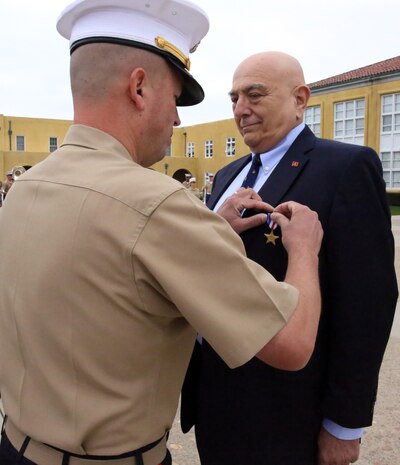 Brig. Gen. James W. Bierman, commanding general of Marine Corps Recruit Depot San Diego and Western Recruiting Region, awards Joe B. Cordileone the Silver Star medal during a morning colors ceremony aboard Marine Corps Recruit Depot San Diego, Sept. 20. Cordileone, now the chief deputy San Diego City Attorney, was awarded the Silver Star medal for his actions during the first Battle of Khe Sanh on April 30, 1967. While serving as a rifleman with Company M, 3rd Battalion, 3rd Marine Regiment, 3rd Marine Division, Cordileone’s company was attacked by a numerically superior enemy force. During the attack Cordileone unhesitatingly advanced multiple times to recover wounded Marines while exposing himself to sniper fire and sustaining fragmentation wounds.  His actions saved the lives of at least 10 Marines. “The Corps taught us discipline, self-discipline, how to face adversity, instilled the will to keep going and continue no matter what,” said Cordileone, a San Diego, Calif. native.  “The Marine Corps showed me that there are things greater than myself.  It made me part of a family that I could rely on no matter what the hardship, no matter what the cost.” 