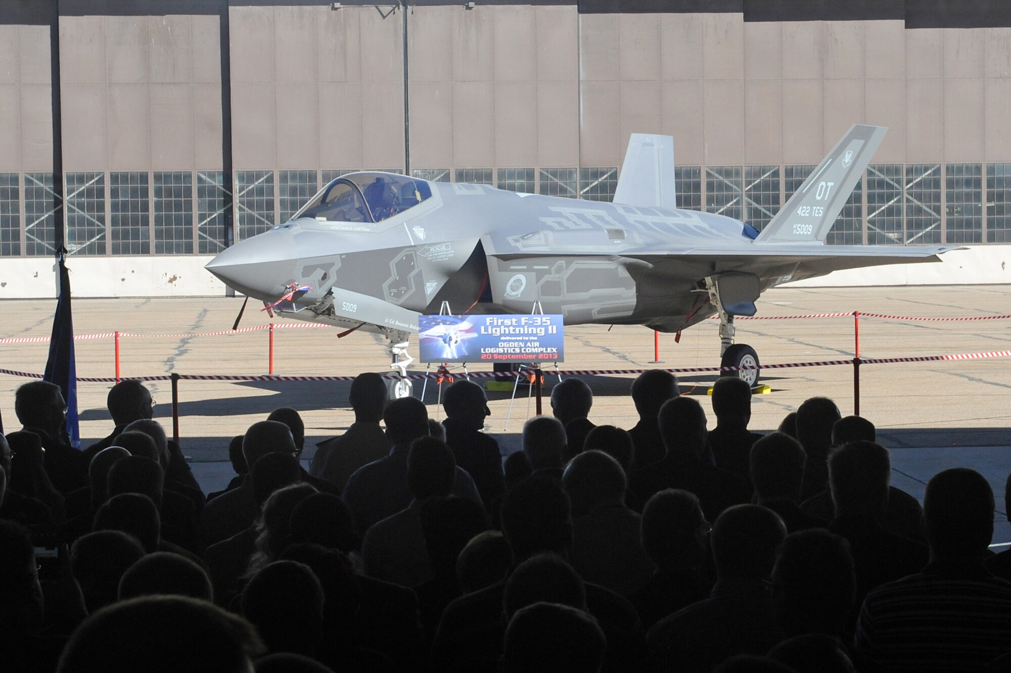 Dignitaries and employees at Hill Air Force Base, Utah, get their first look at the F-35A Lightning II Joint Strike Fighter Sept. 20, 2013. Hill, Lockheed Martin, Utah elected officials and community members gathered for a ceremony to commemorate the beginning of F-35 depot maintenance at the Ogden Air Logistics Complex. The F-35A is a multi-variant, multi-role, fifth generation fighter, and will undergo organic depot modification work at Hill AFB. (U.S. Air Force photo/Alex R. Lloyd)
