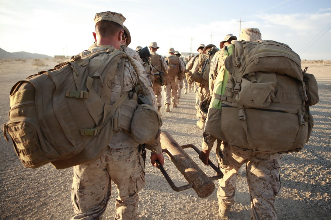 Marines with Fox Company, 2nd Battalion, 3rd Marine Regiment, split the weight of a pole hammer during a hike to a landing zone, Sept. 10, 2013, as part of the Intergrated Training Exercise at Marine Corps Air Ground Combat Center Twentynine Palms, Calif. The Marines spent the night near the landing zone where they were picked up the next day to conduct an air assault course in the Quackenbush training area. (U.S. Marine Corps photo by Cpl. Sarah Dietz)