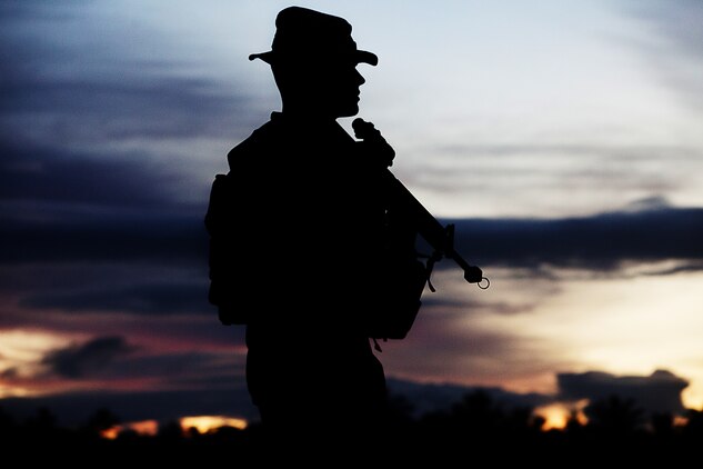 Lance Cpl. Jeremy Coulon, machine gunner and squad leader, weapons platoon, Lima Company, 3rd Battalion, 3rd Marine Regiment, Marine Rotational Force Darwin, and a San Marcos, Texas, native, patrols through a Tongan village on his way to a vehicle checkpoint training evolution as part of Exercise Tafakula 2013 in Tongatapu, Kingdom of Tonga, Sept. 10, 2013.(U.S. Marine Corps Photo by Lance Cpl. Nathan Knapke) 