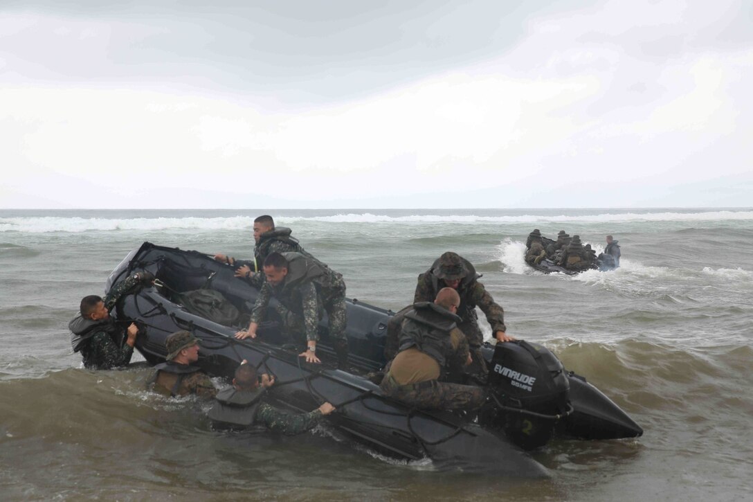 U.S. Marines with the 13th Marine Expeditionary conduct small boat training with Philippine Marines during Amphibious Landing Exercise 2014 (PHIBLEX 14) at Naval Station Leovigildo Gantioqui, San Antonio, Zambales, Philippines, Sept. 18, 2013. PHIBLEX is a bilateral training exercise that demonstrates the commitment of the United States and Republic of the Philippines to mutual security and their long-term partnership. It also ensures the readiness of a bilateral force to rapidly respond to regional humanitarian crises. (U.S. Marine Corps photo by Cpl. David Gonzalez, 13th Marine Expeditionary Unit Combat Camera/Released)