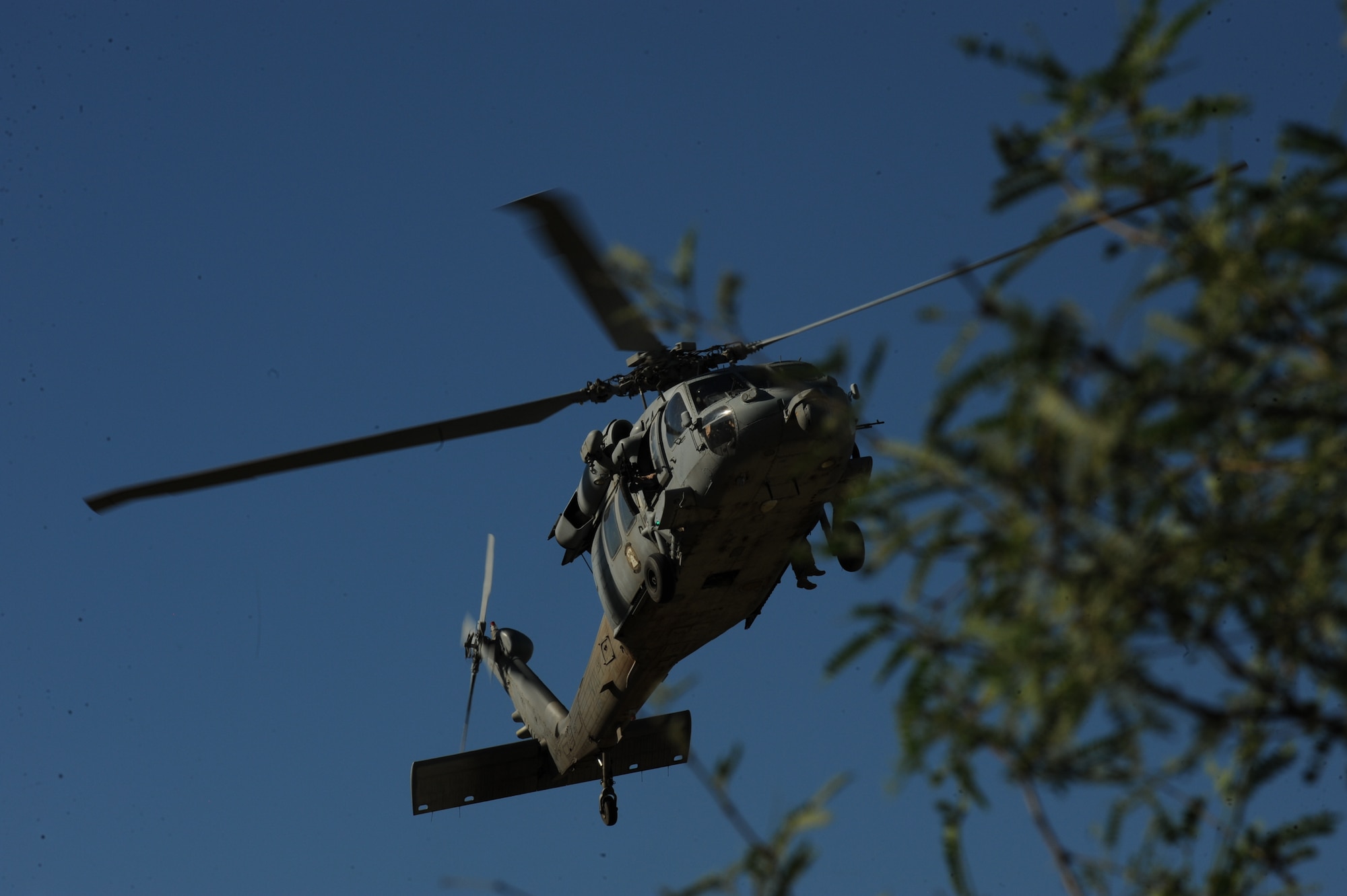 A U.S. Navy MH-60S Knighthawk helicopter searches for downed pilots during a field training exercise Sept. 18, 2013 in southern Arizona.  The MH-60S, from the Helicopter Sea Combat Squadron 23, Naval Air Station North Island, Calif. to participate in joint training with the U.S. Air Force A-10 Thunderbolt squadrons and Combat Search and Rescue units of Davis-Monthan Air Force Base, Ariz. (U.S. Air Force photo by Airman 1st Class Chris Massey/Released)
