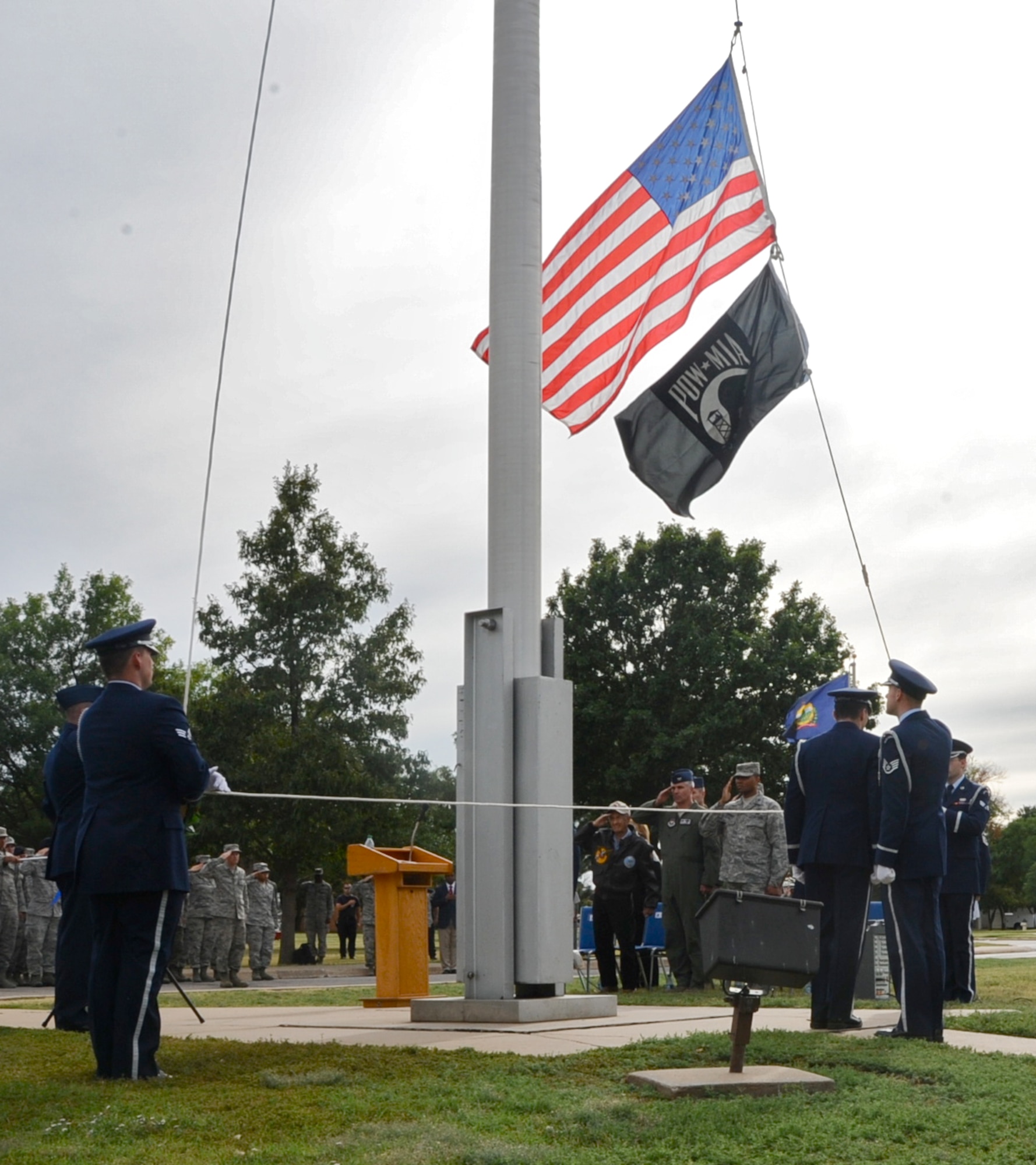 The Silver Talon Honor Guard lowers the flags during a National POW/MIA Recognition Day retreat ceremony held Sept. 20 at Vance Air Force Base, Okla. (U.S. Air Force photo/ Senior Airman Frank Casciotta)