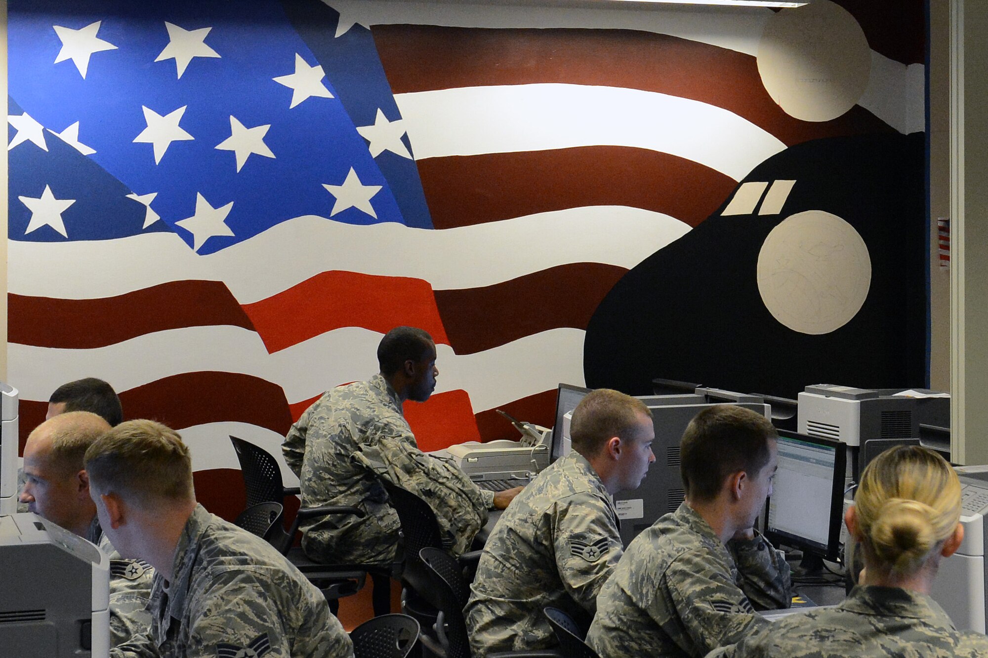 A nearly-finished mural, painted by Airmen from the Rising Four organization, sets the back drop for Airmen studying at the Julius A. Kolb Airmen Leadership School’s learning resource center, Sept. 20, 2013, at Joint Base Lewis-McChord, Wash. Class 13-G are the first 30 students to utilize the learning resource center since the mural was added.  (U. S. Air Force photo/ Airman 1st Class Jacob Jimenez)  