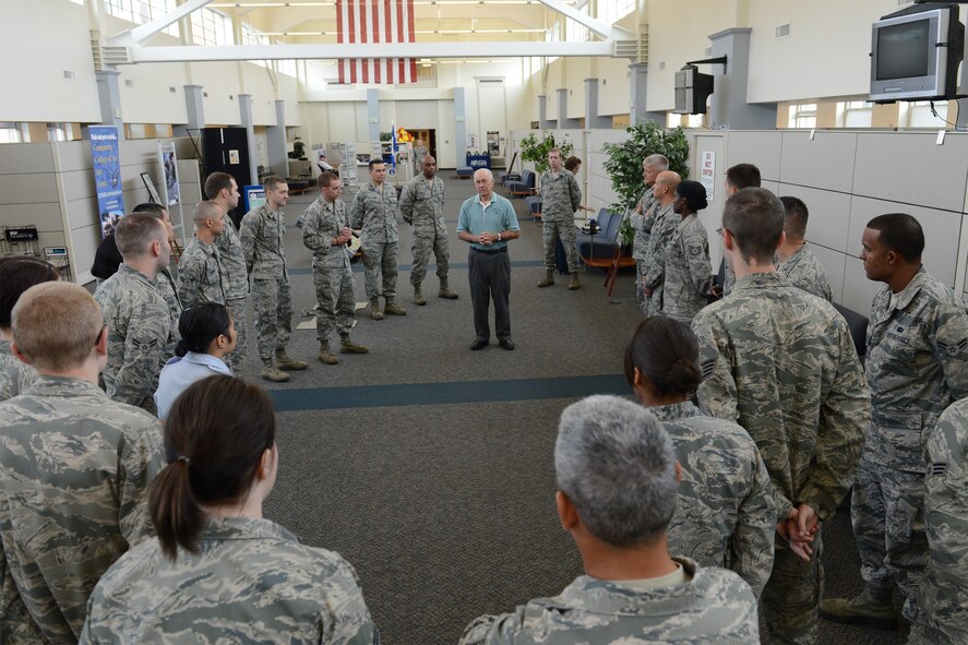 Sam Parish, 8th Chief Master Sgt. of the Air Force, answers questions from 627th Force Support Squadron Airmen about his time served in the Air Force, while visiting the FSS customer service mall, Sept. 9, 2013, at Joint Base Lewis-McChord, Wash. Parish shared with Airmen his experiences in the Air Force and his view on its progression since his retirement. (U.S. Air Force photo/Airman 1st Class Jacob Jimenez) 
