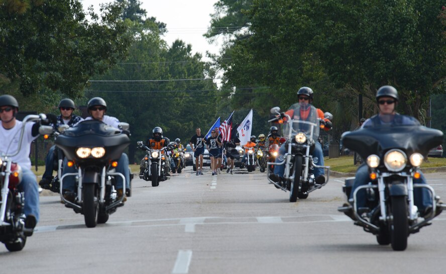 Motorcyclists escort the last of the runners from the 24-hour POW/MIA run at Shaw Air Force Base, S.C., Sept. 20, 2013. A POW/MIA Remembrance ceremony was held at Memorial Lake in honor of those Americans who have fallen, gone missing and/or become prisoners of war. (U.S. Air Force photo by Senior Airman Tabatha Zarrella/Released)