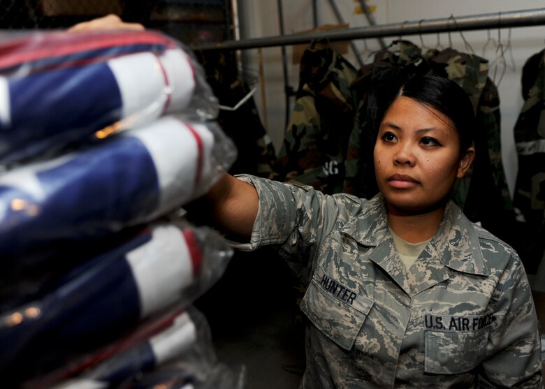 Staff Sgt. Jade Hunter, 28th Force Support Squadron mortuary affairs NCO in-charge, takes a new U.S. flag to display over a transfer case during a training session at Ellsworth Air Force Base, S.D., Aug. 13, 2013. Mortuary affairs ensure that these flags are pressed and folded by an honor guard at the funeral and presented to the family with dignity and honor. (U.S. Air Force photo by Airman 1st Class Anania Tekurio/Released)
