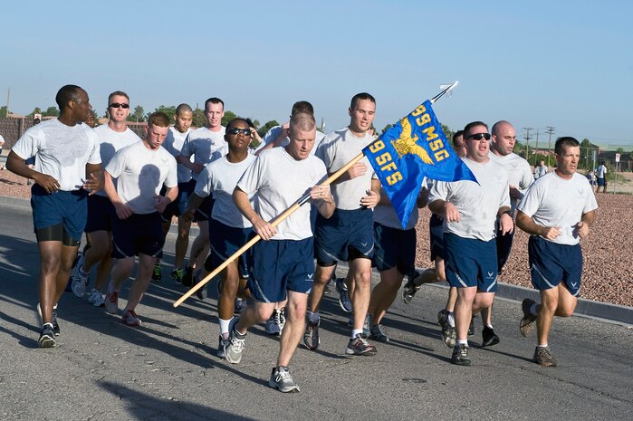Airmen of the 99th Security Forces Squadron run together during the U.S. Air Force’s 66th Birthday 5 kilometer run Sept. 18, 2013, at Nellis Air Force Base, Nev. The origins of the USAF started with the U.S Army Signal Corps Aeronautical Division, a three person unit created in August 1907 to take charge of matters pertaining to military ballooning. (U.S. Air Force photo by Senior Airman Matthew Lancaster)