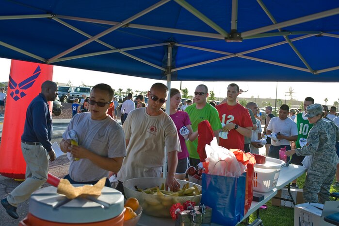 Staff Sgt. Joshua Acosta, 99th Logistics Readiness Squadron cryogenics storage NCO in charge, runs across the finish line first during the U.S. Air Force’s 66th Birthday 5 kilometer run Sept. 18, 2013, at Nellis Air Force Base, Nev. The official date of the founding of the USAF was Sept. 18, 1947. (U.S. Air Force photo by Senior Airman Matthew Lancaster)