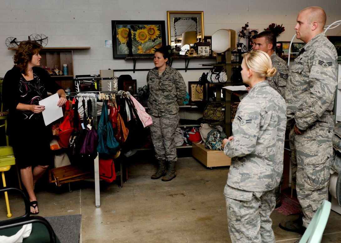 Brenda Eiman, B-One Yard Thrift and Consignment Store manager, explains the many items and resources available to Airmen during a tour of the B-One Yard Thrift and Consignment store at Ellsworth Air Force Base, S.D., Sept. 17, 2013. The store offers eligible Airmen resources ranging from the Airman’s Attic – a loan closet offering necessary household items to the Car Seat Program – which provides Airmen one free convertible infant car seat per child. (U.S. Air Force photo by Airman 1st Class Anania Tekurio/Released)