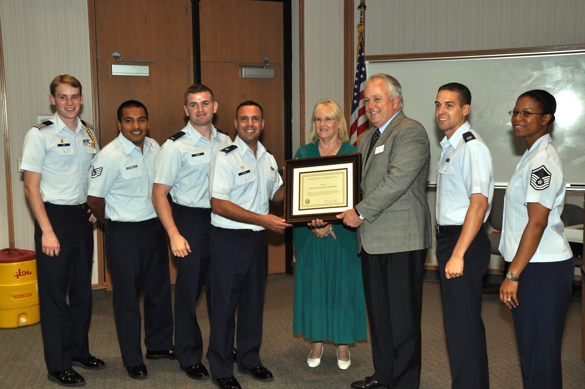SAN ANGELO, Texas – Brian May, Angelo State University president, presents Lt. Col. Pedro Matos, Air Force ROTC Detachment 847 Commander, with a letter of appreciation at ASU Sept. 18. May presented the letter for the detachments hard work throughout the year and for earning the 2013 High Flight award as the best medium-size detachment in the Southwest Region.  (U.S. Air Force photo/ Airman 1st Class Joshua Edwards)