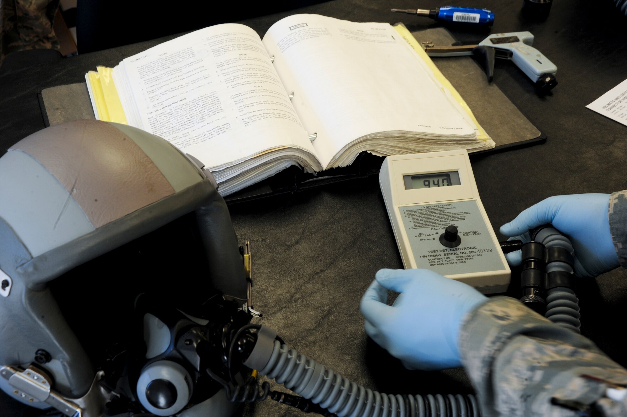 U.S. Air Force Airman 1st Class Jose Padilla, 358th Fighter Squadron aircrew flight equipment apprentice, ensures that the microphone and the headset is serviceable during his daily inspection at Davis-Monthan Air Force Base, Ariz., Sept. 19, 2013. Padilla is an aircrew flight equipment technician, who is responsible for flight equipment such as helmets, oxygen masks, parachutes, floatation devices, survival kits, and many other types of AFE. (U.S. Air Force photo by Airman 1st Class Justin Veazie/Released)