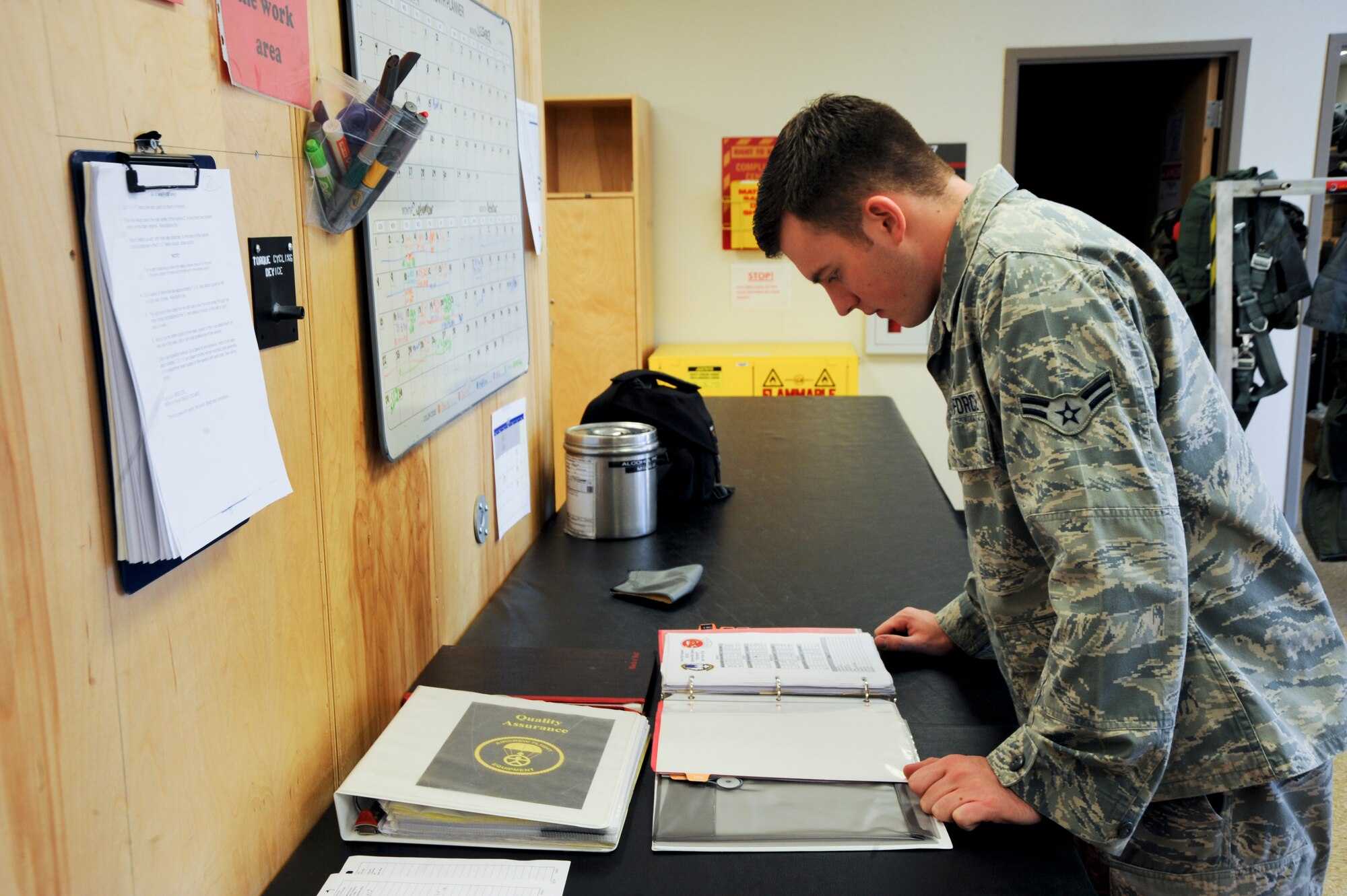 U.S. Air Force Airman 1st Class Kyle Rogers, 358th Fighter Squadron aircrew flight equipment apprentice, checks to see if the right harness is on the correct gear at Davis-Monthan Air Force Base, Ariz., Sept. 19, 2013. Rogers checks the log book to ensure all safety precautions have been taken and mishaps are avoided. (U.S. Air Force photo by Airman 1st Class Justin Veazie/Released)