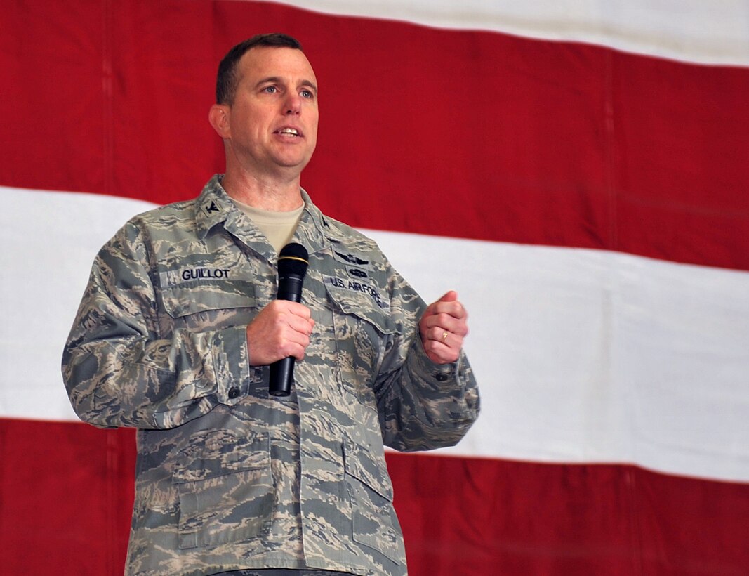 U.S. Air Force Col. Gregory Guillot, 55th Wing commander, tells airmen to “let it out” after successfully completing the consolidated unit inspection from 15-20 Sept. The wing was awarded with an excellent at the Bennie Davis Facility at Offutt Air Force Base, Neb., Sept. 20. (U.S. Air Force photo by Jeff W. Gates/Released)
