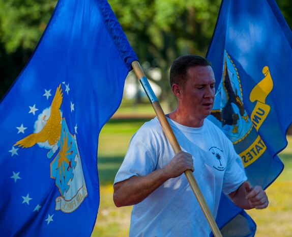 MSgt. Scott Boone, 315th Security Forces Squadron security forces operations superintendent runs with the United States Air Force flag during the POW/MIA Run Sept. 20, 2013, at Joint Base Charleston – Air Base, S.C. Different units from the joint base carried the flag for 30-minute increments from 3:30 p.m. Sept. 19 to 3:30 p.m. Sept. 20 in honor of all POWs and MIAs. Over 660 runners participated in the vigil and logged nearly 2,000 miles. (U.S. Air Force photo/ Airman 1st Class Chacarra Neal)