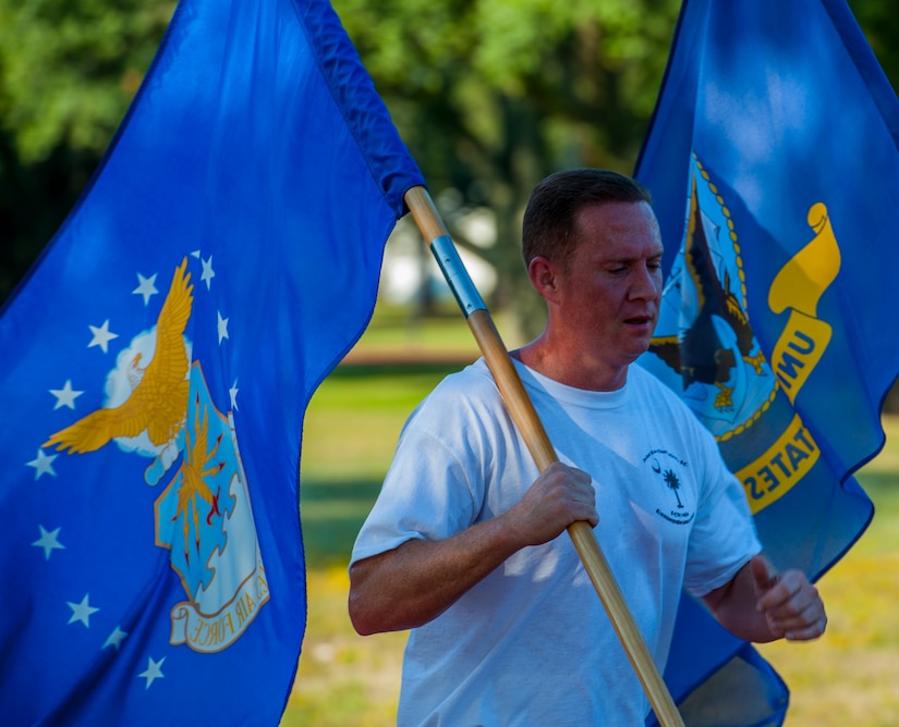 MSgt. Scott Boone, 315th Security Forces Squadron security forces operations superintendent runs with the United States Air Force flag during the POW/MIA Run Sept. 20, 2013, at Joint Base Charleston – Air Base, S.C. Different units from the joint base carried the flag for 30-minute increments from 3:30 p.m. Sept. 19 to 3:30 p.m. Sept. 20 in honor of all POWs and MIAs. Over 660 runners participated in the vigil and logged nearly 2,000 miles. (U.S. Air Force photo/ Airman 1st Class Chacarra Neal)