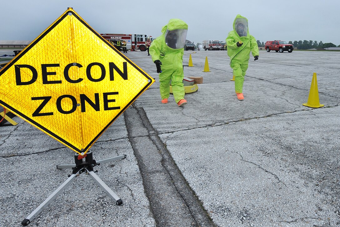 Jason Livermore and Ronald Dawson, both firefighters with the 55th Civil Engineer Squadron, walk over to a simulated chemical spill on the flightline as part of a Consolidated Unit Inspection task evaluation Sept. 17 at Offutt Air Force Base, Neb., The 55th Wing participated in 11 inspections in September, including the CUI from Sept. 15-20. (U.S. Air Force photo by Charles Haymond/Released)