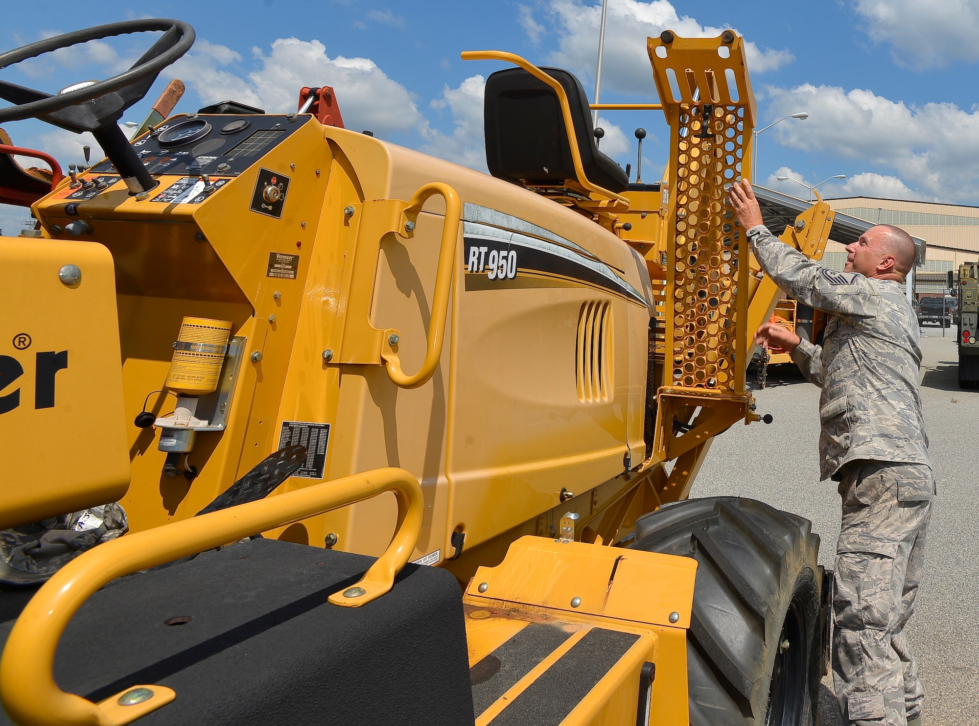 U.S. Air Force Master Sgt. Andrew Jones, a heavy mobile maintenance mechanic with the 202nd Engineering Installation Squadron, Georgia Air National Guard, performs an operational inspection on a trencher, Robins Air Force Base, Ga., Sept. 10, 2013.  Working as a dual-status civil service technician, Jones is responsible to ensure all vehicles and heavy equipment used by the squadron is mission ready at all times. (U.S. Air National Guard photo by Tech Sgt. Regina Young/Released)