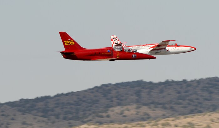 Two jet aircraft race for position during the 50th Annual National Championship Air Races at Stead Airport, Reno, Nev., Sept. 14, 2013. These aircraft often reach speeds close to 500 mph. (U.S. Air Force photo by Staff Sgt. Robert M. Trujillo/Released)