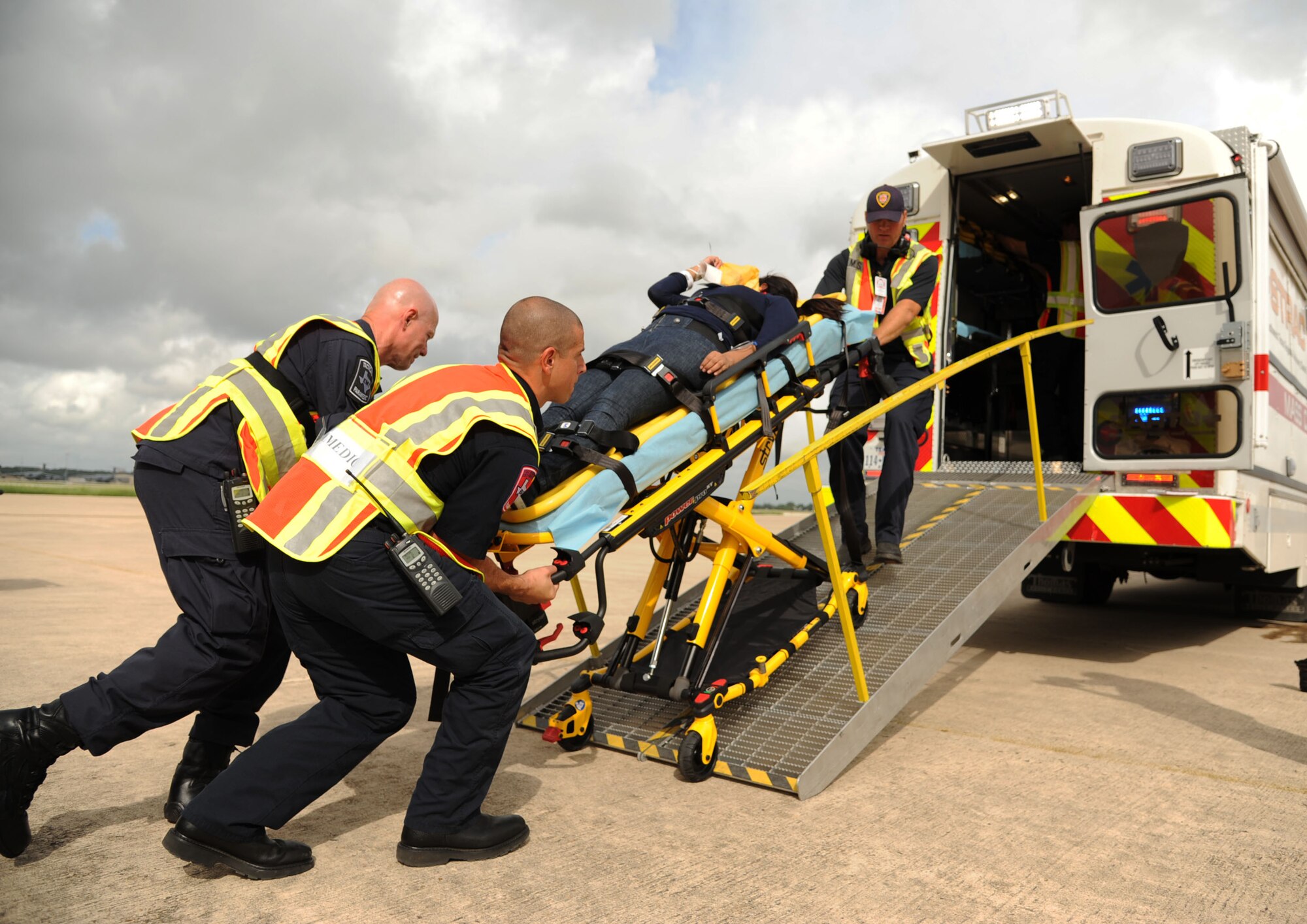 Medics place a patient on an ambulance on the flight line at Kelly Air Field during the San Antonio Mass Casualty Exercise Event Sept. 19, 2013, at Port San Antonio. The exercise was designed to test the ability of military and civilian medical groups to work together to provide fast and efficient care to patients in the event of a crisis. (U.S. Air Force photo by Staff Sgt. Jerilyn Quintanilla)