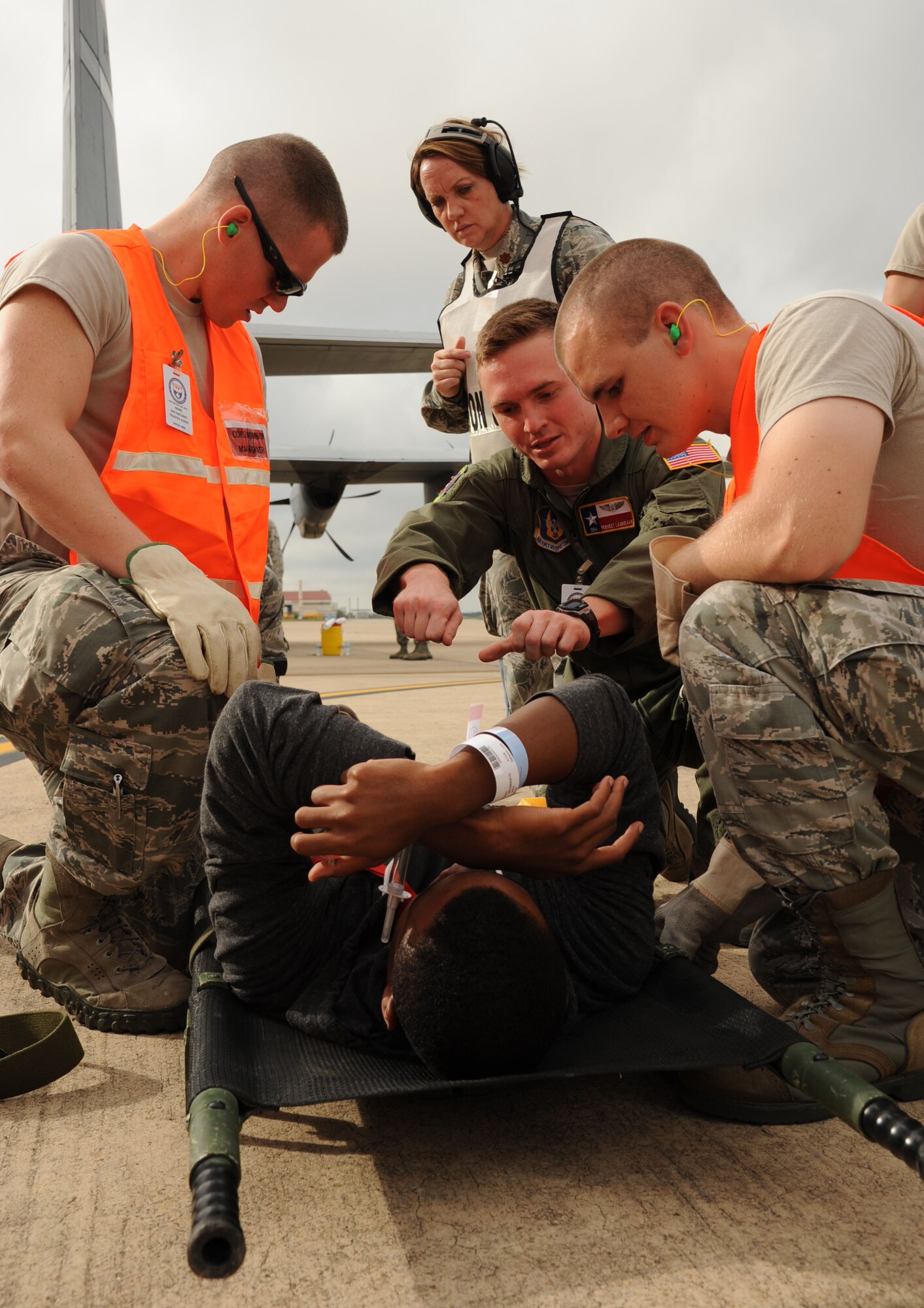 Medics tend to a patient at Kelly Air Field during the San Antonio Mass Casualty Exercise Event, a disaster scenario designed to test the ability of area hospitals to respond to a sudden spike in trauma patients, Sept. 19, 2013.  Hangar 1610 served as the hub for patient processing and transportation to area hospitals according to injury and bed availability. (U.S. Air Force photo by Staff Sgt. Jerilyn Quintanilla)