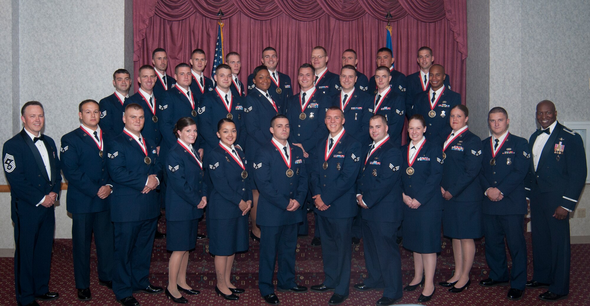 Airmen in Airman Leadership School Class 13-F pose for a photo with Chief Master Sgt. Michael Abbott, 153rd Airlift Wing command chief, and Col. Carl Jones, 90th Missile Wing vice commander, before graduating in a ceremony in front of family and friends Sept. 18, 2013. Enlisted Airmen are required to graduate ALS before they are allowed to supervise other Airmen. (U.S. Air Force photo by Airman 1st Class Jason Wiese)