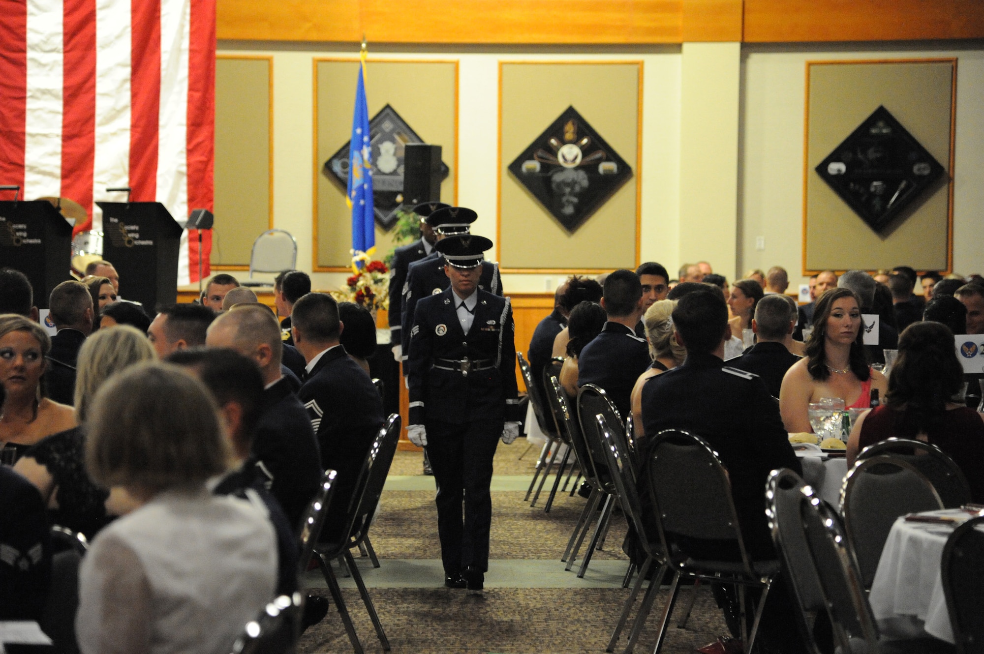 Members of the Malmstrom Air Force Base Honor Guard depart after performing a POW/MIA tribute during the Air Force Ball.  One table, fully prepared, stood empty in rememberance of the Airmen and fellow service members who made the ultimate sacrifice. (U.S. Air Force photo/Airman 1st Class Collin Schmidt)


