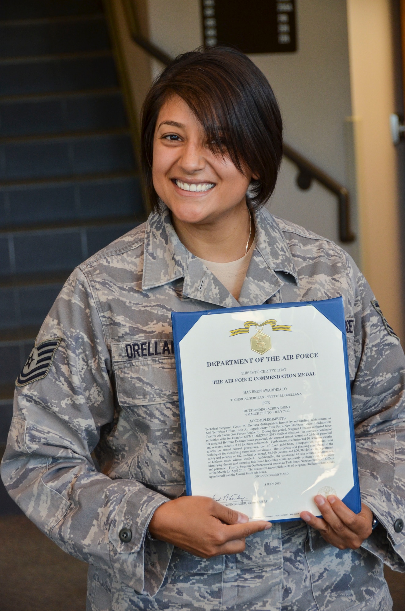Tech Sgt. Yvette Orellana, 12th Air Force (Air Forces Southern) Force Protection Office, smiles after receiving an Air Force Commendation medal at Davis-Monthan Air Force Base, Ariz., Sept. 20, 2013. Orellana is receiving her Commendation medal for her accomplishments while serving as the Anti-Terrorism Officer for the 12th Air Expeditionary Task Force-New Horizons Belize, Headquarters 12th Air Force (Air Forces Southern). (U.S. Air Force photo by Staff Sgt. Adam Grant/Released