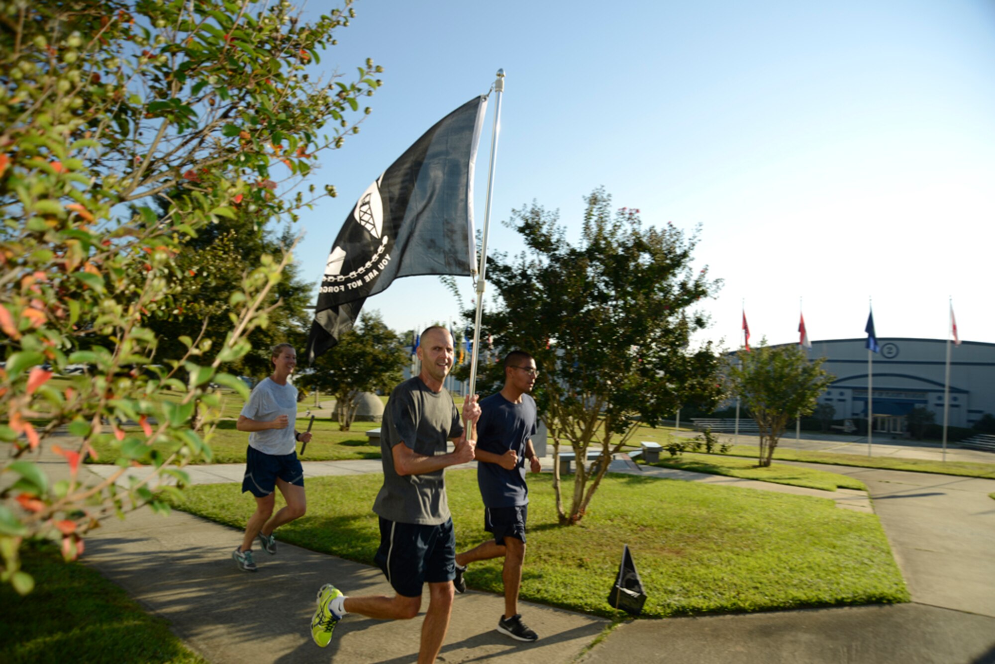 Military members at Robins run with the POW/MIA flag during a 24-hour run Wednesday and Thursday which honored the memory of thousands of our nation's heroes who didn’t return home from battle. The run was in advance of National POW/MIA Recognition Day, which is observed annually on the third Friday in September. Local military members also held a commemoration ceremony at the base on Thursday.  (U.S. Air Force photo by Ed Aspera)
