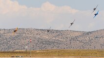Several vintage fighter aircraft race for position around a plyon during the 50th Annual National Championship Air Races at Stead Airport, Reno, Nev., Sept. 14, 2013. Aircraft follow 50ft. pylons spread across a 3 to 8 mile course. (U.S. Air Force photo by Staff Sgt. Robert M. Trujillo/Released)
