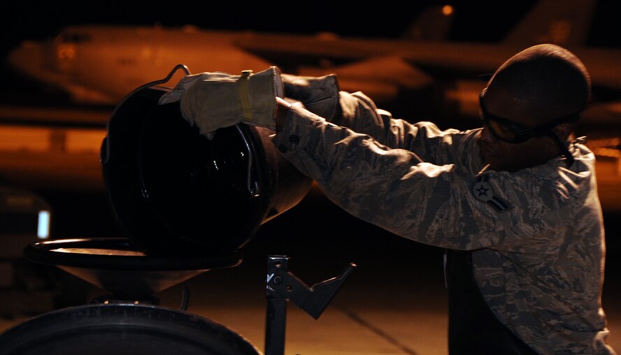Staff Sgt. Michael Demokowicz, 2nd Logistics Readiness Squadron vehicle operations swing shift assistant NCO in-charge, lowers a vehicle off a flatbed wrecker on Barksdale Air Force Base, La., Sept. 13, 2013. Vehicle operations is responsible for moving aircrew and cargo to and from aircraft, parts pick-up and delivery, vehicle issue and vehicle towing day or night. (U.S. Air Force photo/Staff Sgt. Jason McCasland)