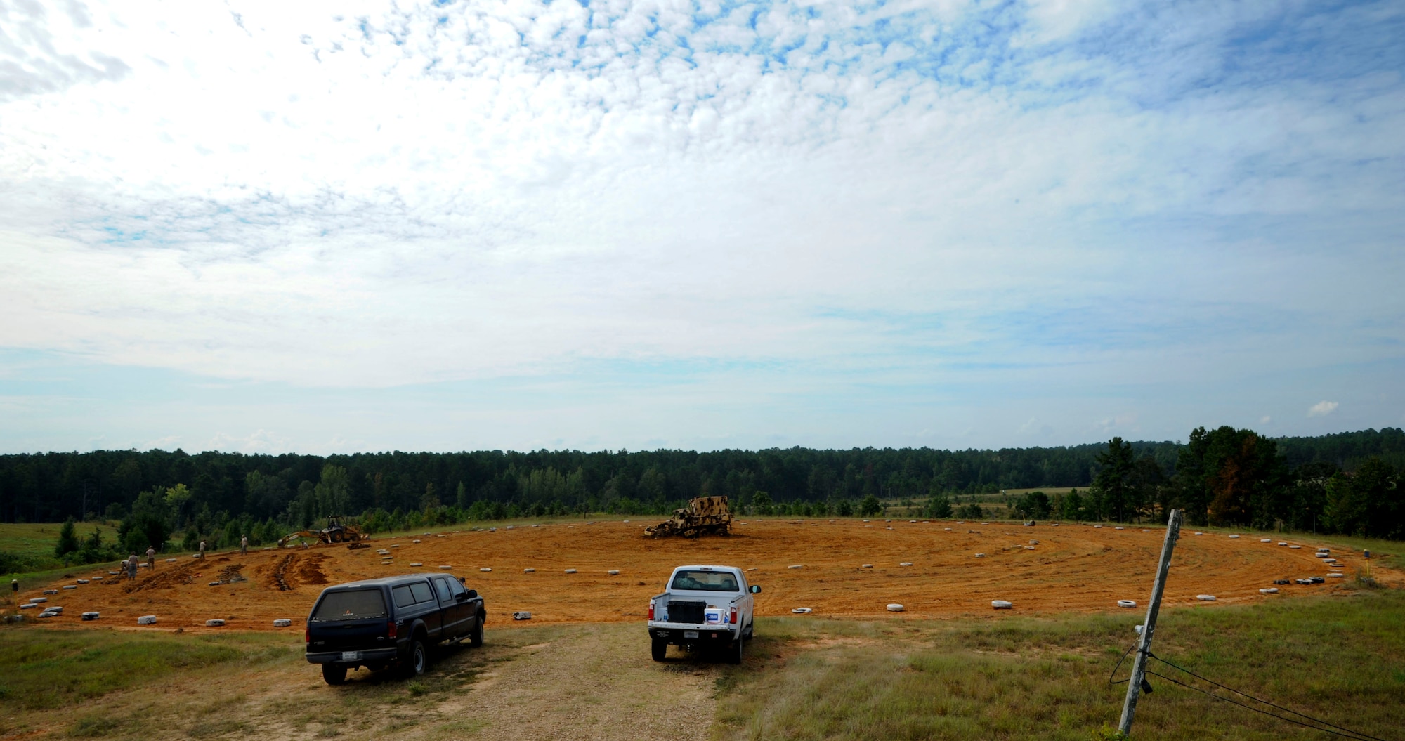 Airmen from the 2nd Civil Engineer Squadron Explosive Ordnance Disposal flight, place BDU-12s into man-made trenches at the main target circle at the Claiborne Bombing and Gunnery Range in Alexandria, La., Sept. 18, 2013. Pilots flying the B-52H Stratofortess and the A-10 Thunderbolt II use the circle for target practice and needs to be cleared yearly of all ordnance. (U.S. Air Force photo/Senior Airman Joseph A. Pagán Jr.)