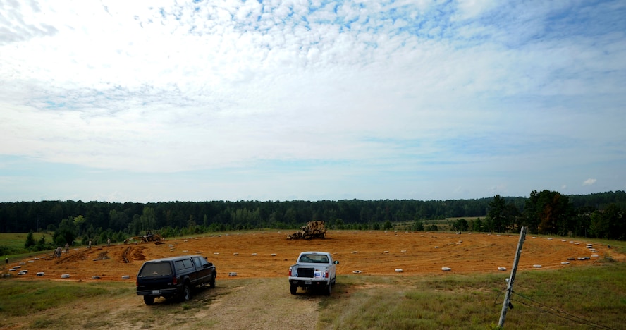 Airmen from the 2nd Civil Engineer Squadron Explosive Ordnance Disposal flight, place BDU-12s into man-made trenches at the main target circle at the Claiborne Bombing and Gunnery Range in Alexandria, La., Sept. 18, 2013. Pilots flying the B-52H Stratofortess and the A-10 Thunderbolt II use the circle for target practice and needs to be cleared yearly of all ordnance. (U.S. Air Force photo/Senior Airman Joseph A. Pagán Jr.)