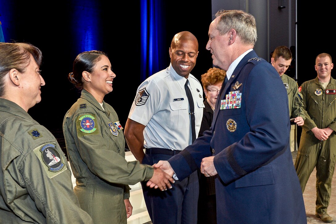 Air Force Chief of Staff Gen. Mark A. Welsh III shakes hands with Capt. Adriana Valadez, a 433rd Aeromedical Evacuation Squadron flight nurse, highlighted during his Air Force Update keynote address during the Air Force Association's 2013 Air & Space Conference and Technology Exposition Sept. 17, 2013, in Washington, D.C. During his address, Welsh emphasized how each Airman contributes to Global Vigilance, Global Reach and Global Power for America. (U.S. Air Force photo/Michael J. Pausic) (Photo by Michael J. Pausic )

