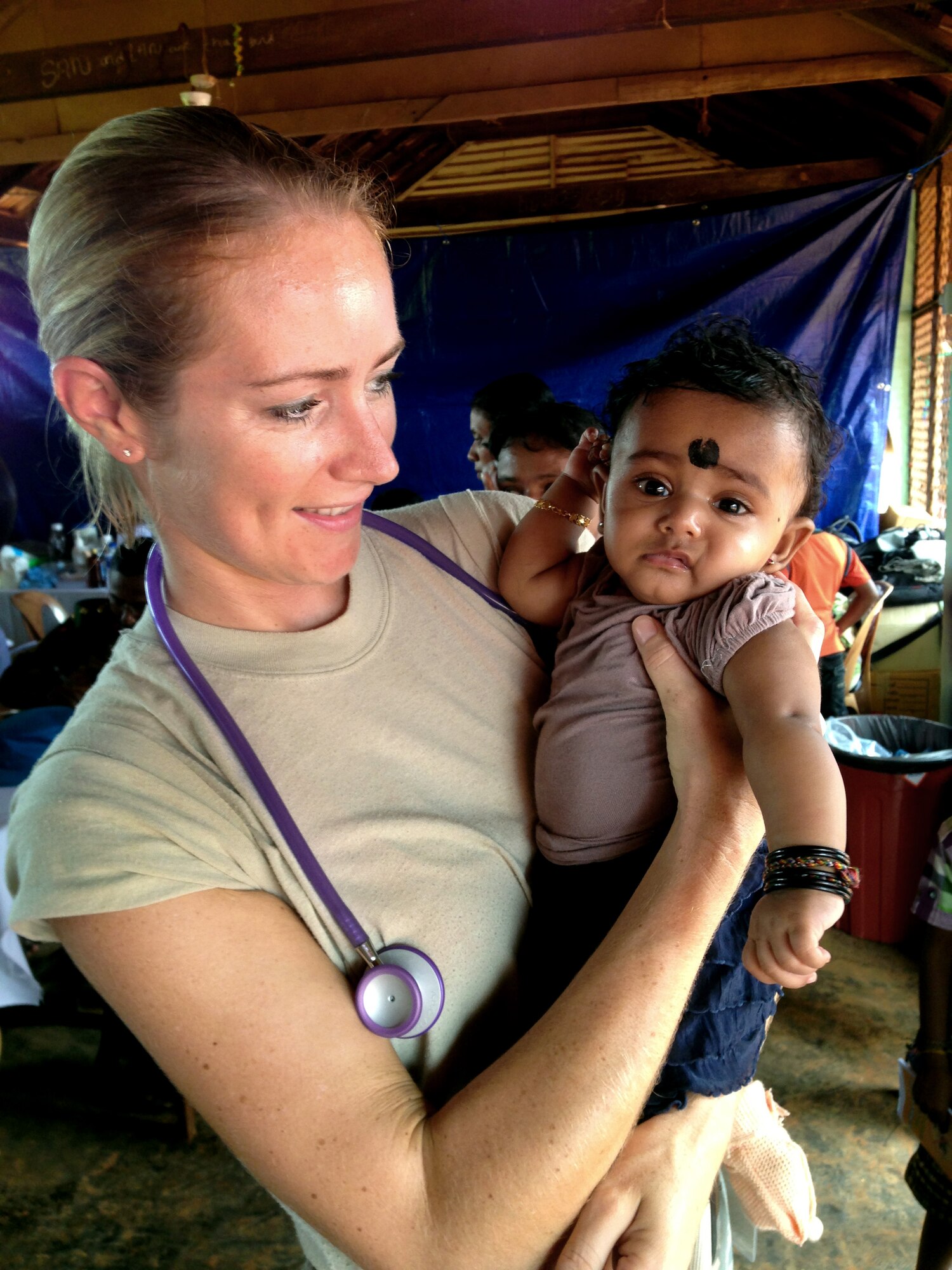 Air Force Tech. Sgt. Misty Ray, 142nd Fighter Wing Medical Group, hold a child to be examined during the Pacific Angel Mission in the Jaffna Peninsula of Sri Lanka, July 28- Aug.18. (Photo courtesy of Tech. Sgt. Misty Ray, 142nd Fighter Wing Medical Group).