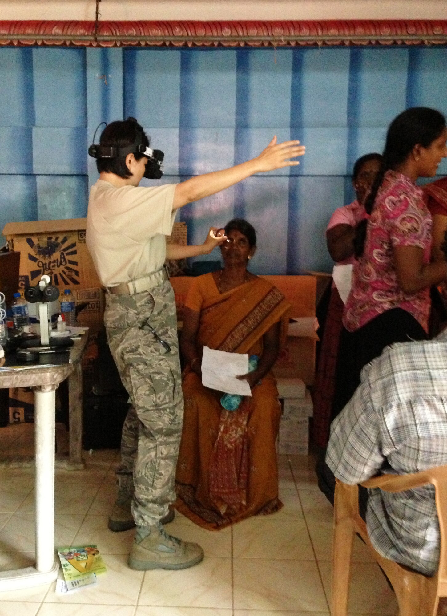 Air Force Lt. Col. Thuy Tran, 142nd Fighter Wing Medical Group, performs optometry examinations with a patient during the Pacific Angel Mission in the Jaffna Peninsula of Sri Lanka, July 28- Aug.18. (Photo courtesy of Tech. Sgt. Misty Ray, 142nd Fighter Wing Medical Group).
