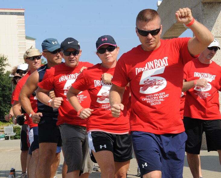 Members from the Air Force Global Strike Command practice their rowing technique during the 5th annual Red River Dragon Boat Festival in Shreveport/Bossier City, La., Sept. 14, 2013. The challenge of dragon boat racing lies not in the paddling technique but rather in synchronizing with 19 other paddlers on the boat through the entire race course. (U.S. Air Force photo/Senior Airman Sean Martin)