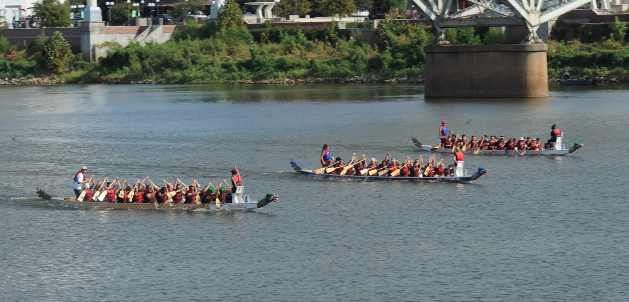 Teams consisting of members from the 2nd Bomb Wing and 8th Air Force row in the 5th annual Red River Dragon Boat Festival in Shreveport/Bossier City, La., Sept. 14, 2013. This year 30 teams from the Ark-La-Tex area registered for the race. The Hoitai and the Foo Dogs team won the race for the third year in a row with a time of 1:11:06. More than half of the team members are assigned to the 2nd BW. (U.S. Air Force photo/Senior Airman Sean Martin)
