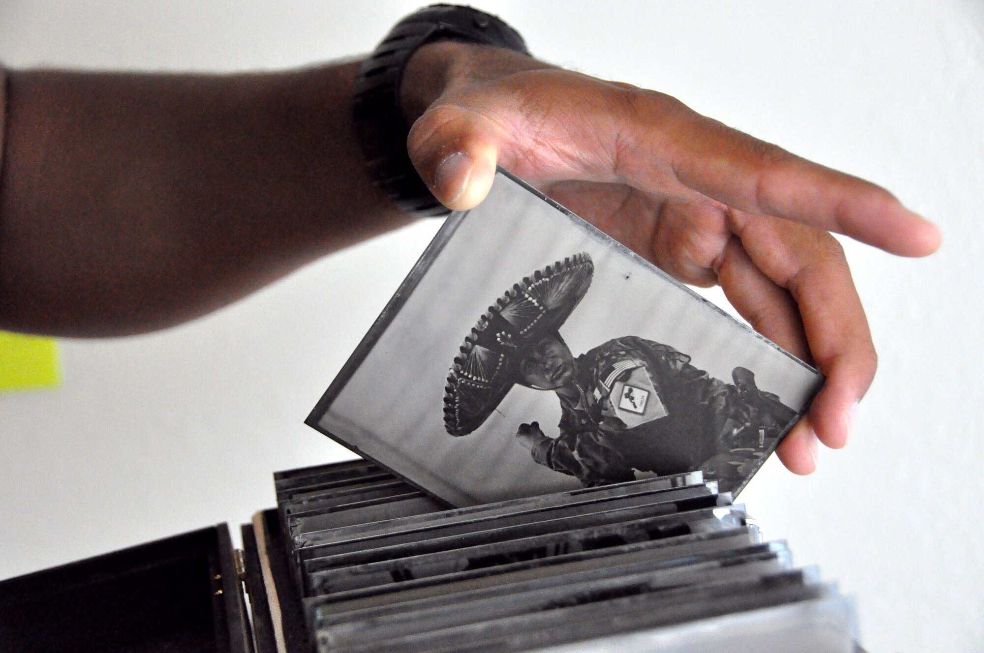 Staff Sgt. Ed Drew pulls one of his tin photos out of his collection Sept. 5 in Albany, CA. He has over 75 in his collection and stores them in wooden boxes to protect them.(U.S. Air Force photo/ Staff Sgt. Patrick Harrower)